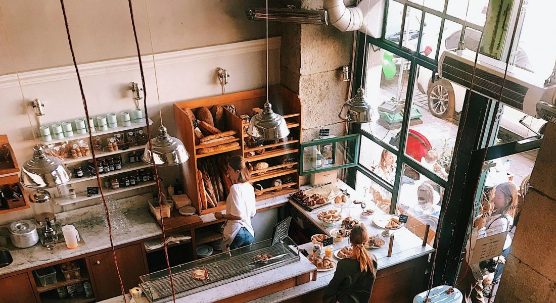 Areal shot of of coffee shop serving coffee and pastries with customers at tables